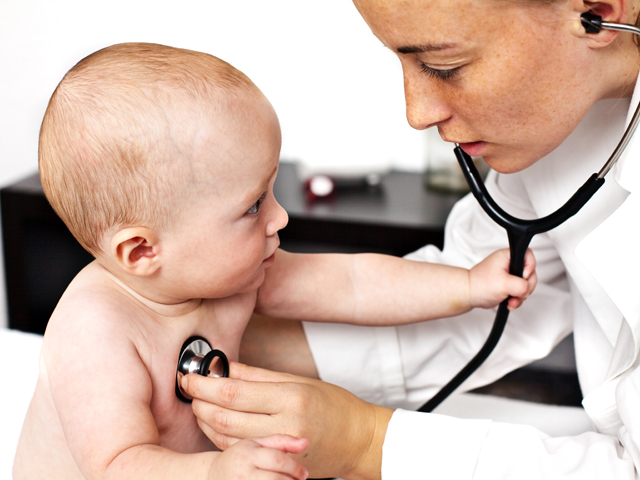 A pediatric doctor examining a child with a stethoscope